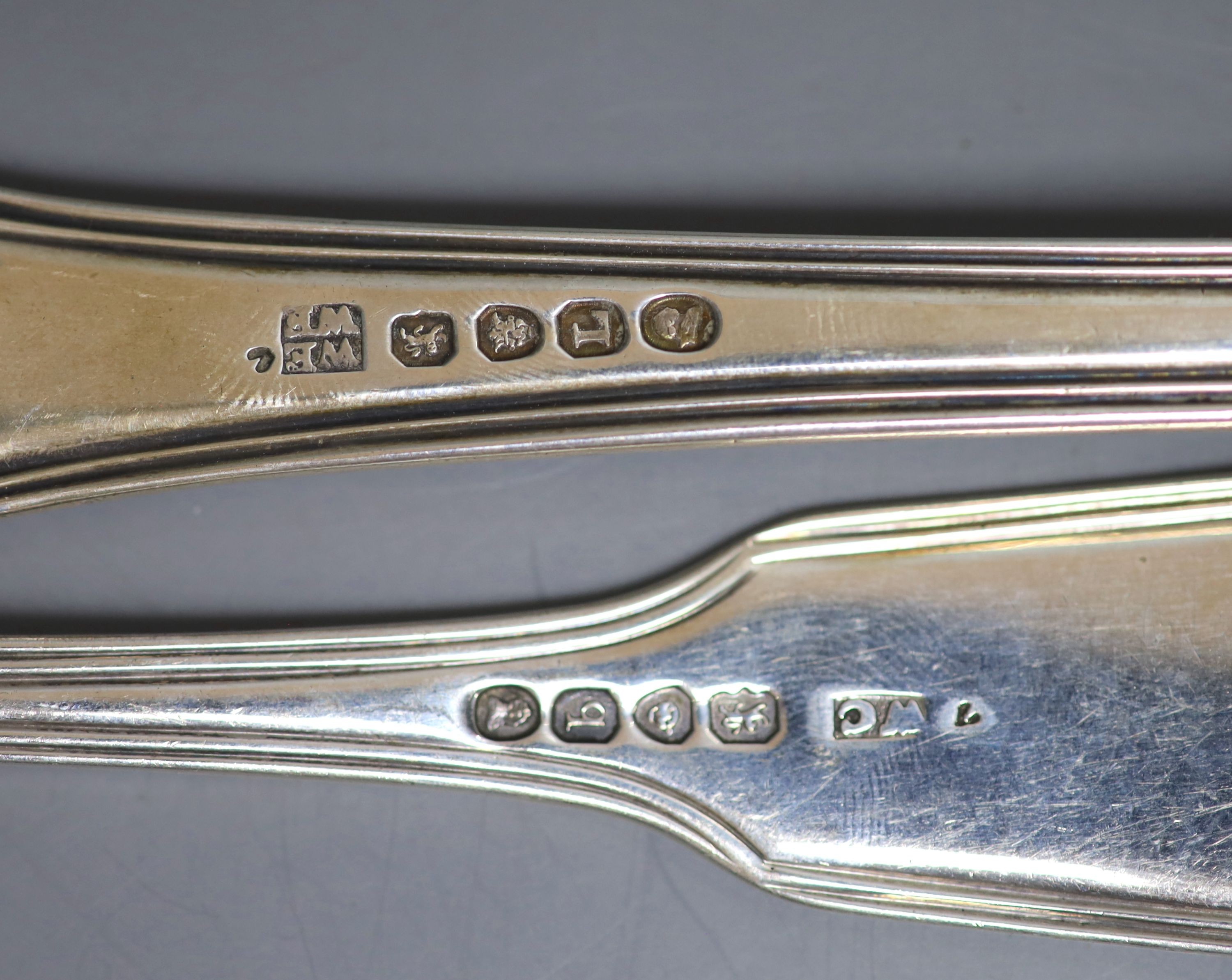 A harlequin set of six 19th century silver fiddle, thread and shell pattern tablespoons and a George III silver hourglass pattern basting spoon, by Eley & Fearn, 20oz.